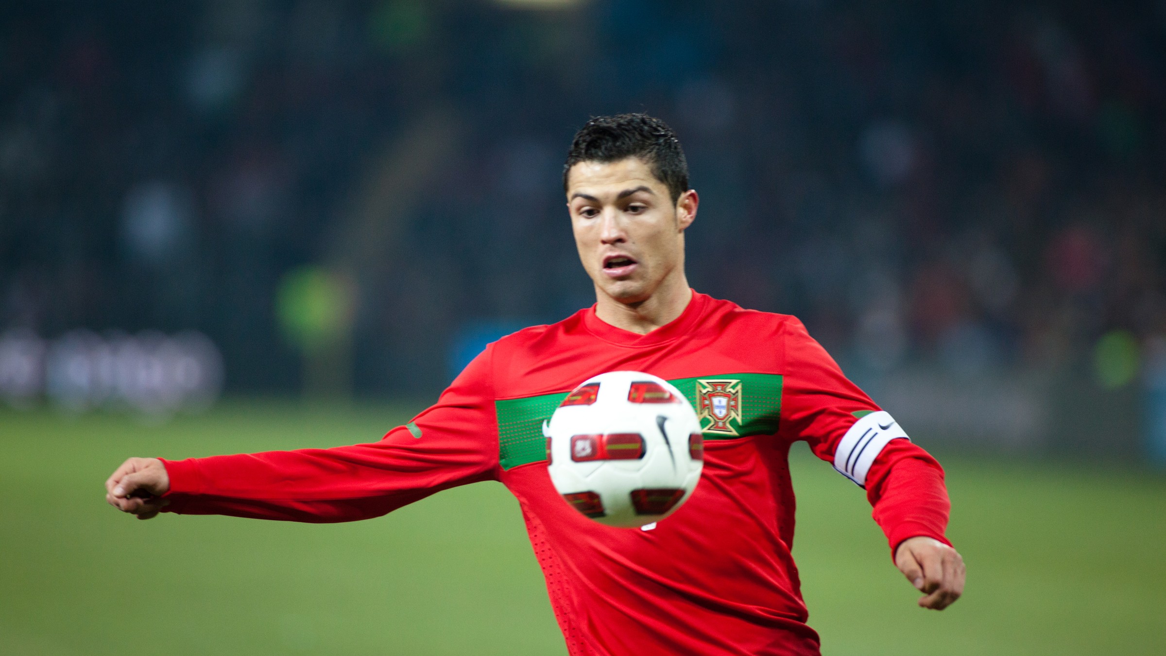 Cristiano Ronaldo controlling the ball in Portugal's red home shirt.