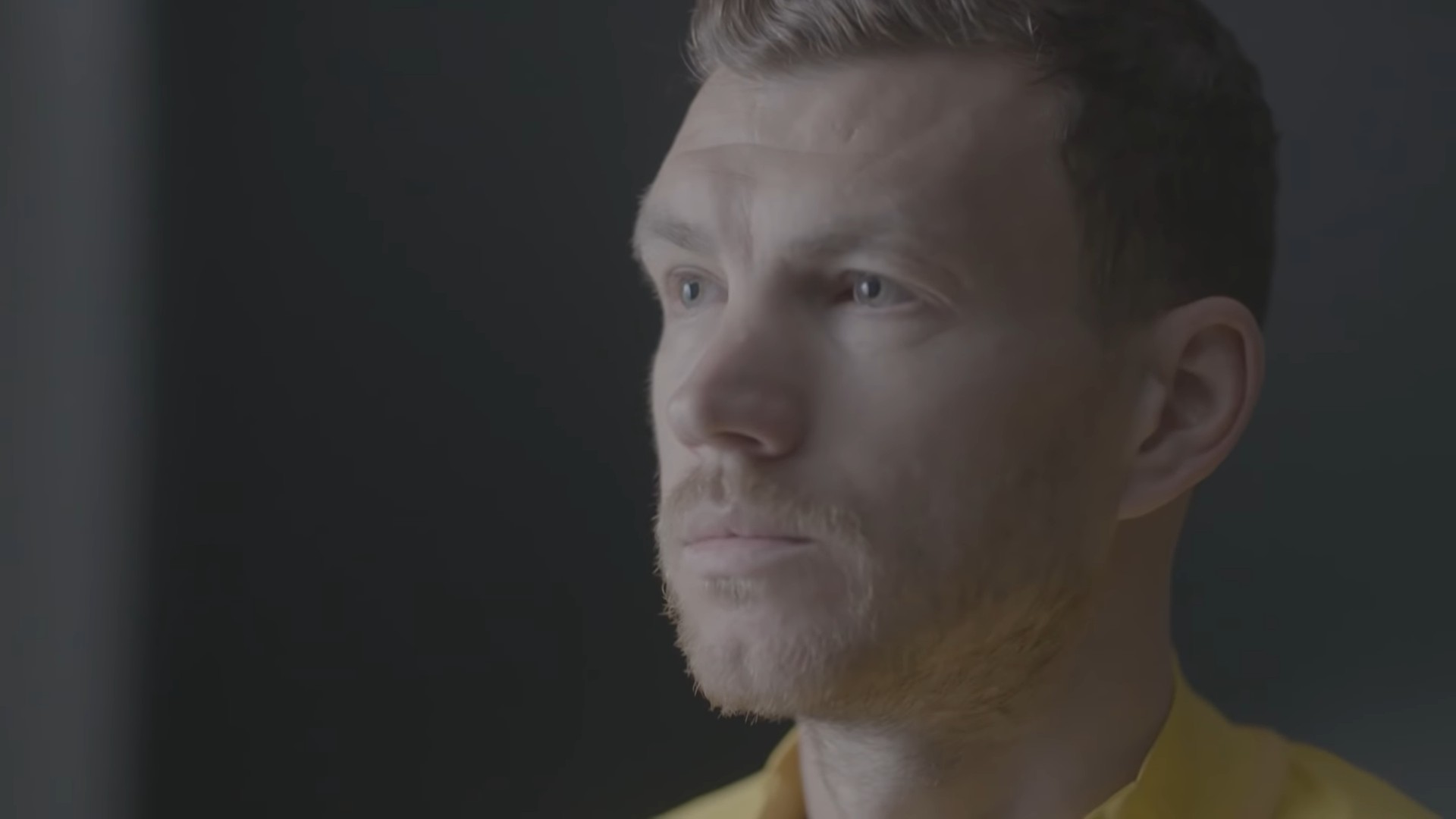 Edin Džeko in a reflective close-up portrait.