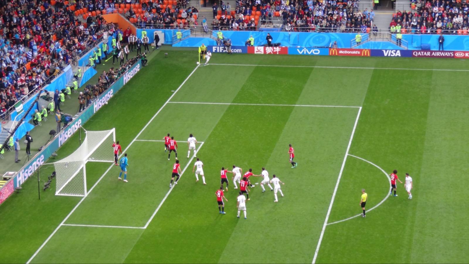 Players contest a corner in a crowded penalty area during Egypt v Uruguay at the 2018 FIFA World Cup.